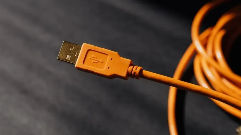 주황색 USB 케이블 커넥터 부분을 근접 촬영한 모습